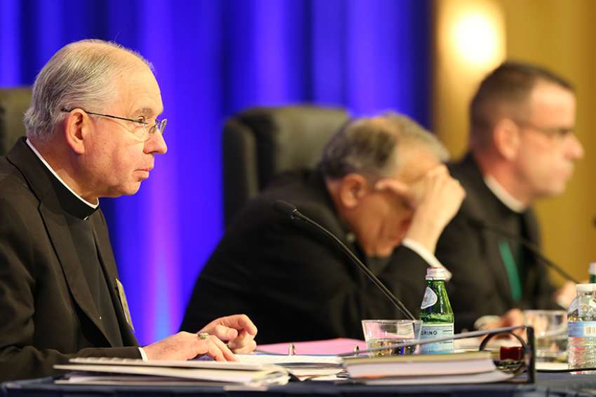  Archbishop Jose H. Gomez of Los Angeles, vice president of the U.S. Conference of Catholic Bishops, gives the opening prayer Nov. 13 at the bishops&#039; fall general assembly in Baltimore. Also pictured are Cardinal Daniel N. DiNardo of Galveston-Houston, USCCB president, and Msgr. J. Brian Bransfield, USCCB general secretary. 