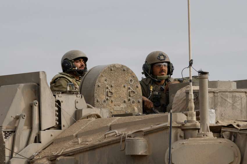 Israeli soldiers are seen on a tank as they reenter Israel from Gaza near the Israel-Gaza border in southern Israel Jan. 11, 2024, amid the ongoing conflict between Israel and the Palestinian Islamist group Hamas.