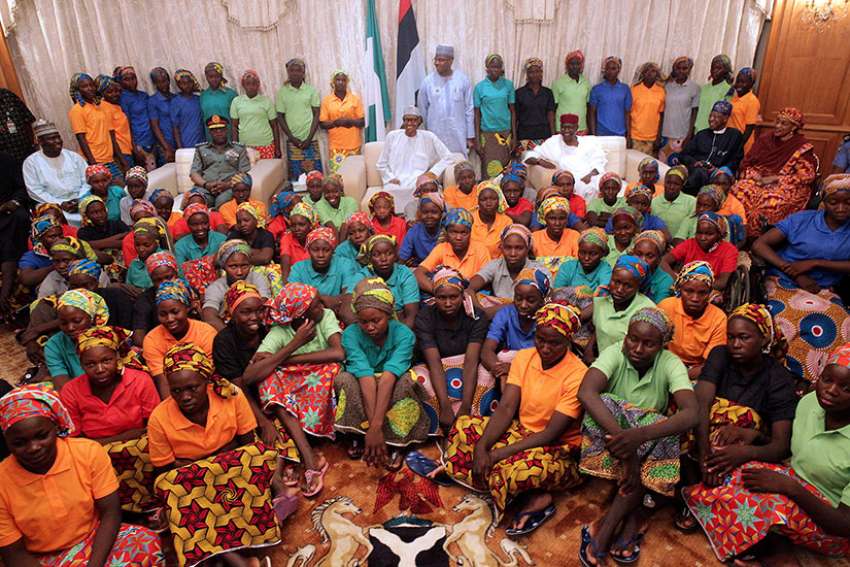 A group of Chibok girls are seen with Nigerian President Muhammadu Buhari in Abuja, Nigeria, May 7. The girls were held captive for three years by Boko Haram militants.