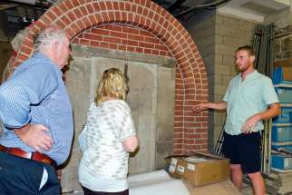 Tomas Nugent shows off his handiwork in the crypts to his parents, Michael and Kathleen.