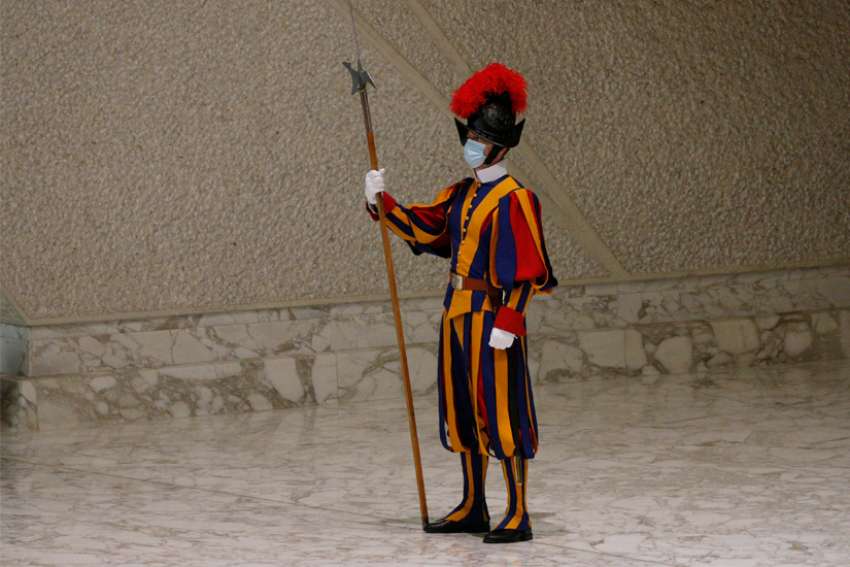 A Swiss Guard is pictured before Pope Francis&#039; general audience in the Paul VI hall at the Vatican Sept. 22, 2021. Three members of the Swiss Guard have hung up their halberds rather than be vaccinated against COVID-19, and three others were temporarily suspended in early October as they were completing the vaccination cycle, the spokesman for the guards told a Swiss newspaper.