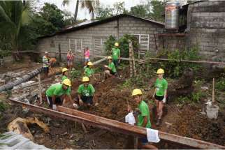 Above, volunteers are digging out the foundation for a new home.