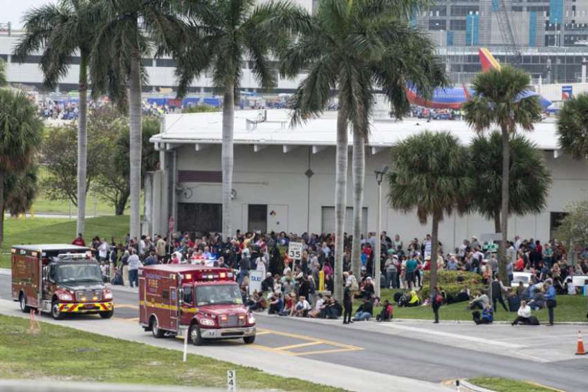 Firemen and ambulances wait outside Fort Lauderdale&#039;s airport in Florida Jan. 7, after a gunman opened fire killing at least five people and injuring eight more. Olga Woltering of Transfiguration Catholic Church in Marietta, Ga., was one of the victims killed in the shooting.