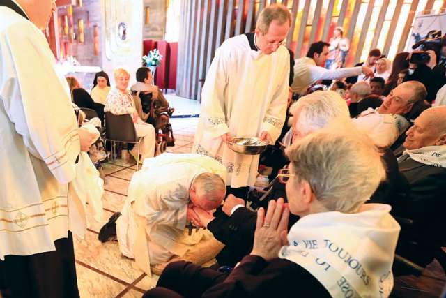 Pope Francis kisses the foot of a disabled person at Our Lady of Providence Centre during Holy Thursday Mass in Rome last year.
