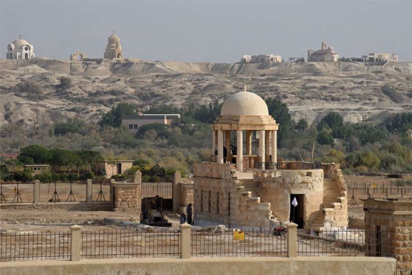 Churches stand on the hill in Jordan behind the Franciscan Chapel of St. John The Baptist at Qasr al-Yahud, on the West Bank of the Jordan River. The bullet-marked chapel was returned to the Franciscan Custody of the Holy Land after being closed by the Israelis in 1967 because of land mines.