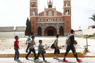  Children walk past a church in the Mexican state of Tlaxcala in this 2015 file photo. 