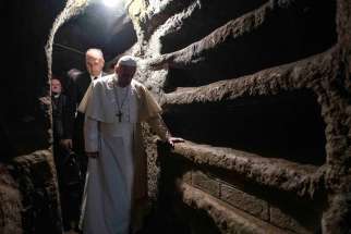 Pope Francis walks through the Catacombs of Priscilla where he celebrated Mass in Rome Nov. 2, 2019, the feast of All Souls.