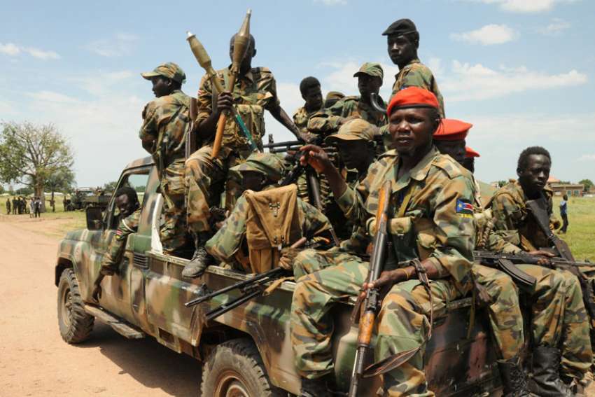 Soldiers with the People&#039;s Liberation Army patrol the camp of Lalo following heavy fighting in late October near Malakal, South Sudan. The Sudan Catholic Bishops&#039; Conference, which includes the bishops of Sudan and South Sudan, said &quot;there is nothing more needed than forgiveness&quot; to heal the differences both countries have experienced for decades.