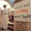 A sign in response to the violence in Syria is seen during a Feb. 11 Mass at a church in the West Bank town of Ramallah. As a sectarian conflict in Syria intensified, Pope Benedict XVI called on all Syrians to begin a process of dialogue and reminded the government of its duty to recognize its citizens&#039; legitimate demands.