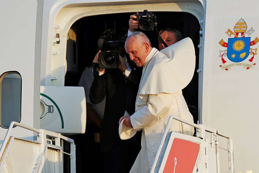 Reporters follow Pope Francis into the plane as he board at Tocumen International Airport after attending World Youth Day in Panama City Jan. 27, 2019. 