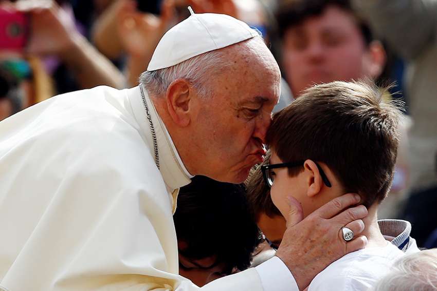  Pope Francis kisses a child during his general audience in St. Peter&#039;s Square at the Vatican May 2.