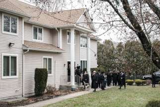 People gather at Rabbi Chaim Rottenberg&#039;s residence in Monsey, N.Y., Dec. 29, 2019. A machete-wielding man attacked the residence during a Hanukkah celebration the night before.
