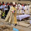 Bishop Martin Igwemezie Uzoukwu of Minna, Nigeria, walks near the coffins of some of the victims of a 2012 Christmas bombing at St. Theresa Catholic Church in Madalla, Nigeria, during a funeral for the victims. Several Nigerian bishops criticized the gov ernment for considering granting amnesty to Boko Haram, an Islamist sect blamed for the deaths of at least 1,400 people since 2010.