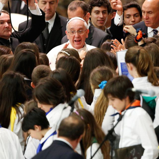 Youths surround Pope Francis as he meets with students from Jesuit schools June 7 in Paul VI hall at the Vatican.