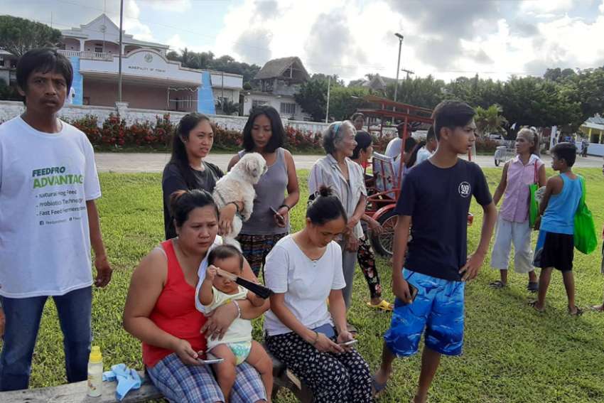 People gather on a field after twin earthquakes struck Batanes province on the northernmost island of the Philippines, July 27, 2019. Bishop Danilo Ulep of the Batanes prelature has appealed for prayers and help for victims of the disaster.
