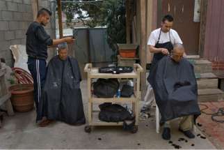 Volunteers give free haircuts to homeless men at the Padre Chava breakfast center in the border city of Tijuana, Mexico, April 27.