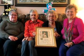 George and Olive Heron sit between two of their daughters, Susan, left, and Janice, who can also boast of long marriages. The Herons are holding a certificate they received from St. Pope John Paul II on the occasion of their 50th wedding anniversary 21 years ago.