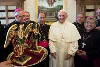 Pope Francis poses with members of the Bolivian bishops&#039; conference during a Sept. 18 meeting at the Vatican. 