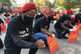 Men kneel during a protest outside the U.S. Embassy in Pretoria, South Africa, June 8 in an anti-racism rally following the May 25 death of American George Floyd.