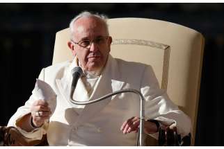 Pope Francis holds his zucchetto as he leads his general audience in St. Peter&#039;s Square at the Vatican Dec. 10. In his talk, the pope reviewed the October extraordinary Synod of Bishops on the family.