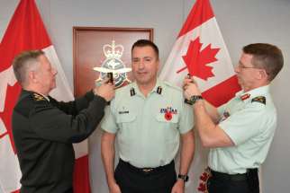General Jonathan Vance, Chief of the Defence Staff, Major-General Guy Chapdelaine and Lieutenant-General Charles Lamarre as Chapdelaine receives the insignia of his new rank Nov. 7. 
