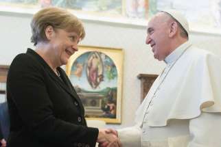 Pope Francis shakes hands with German Chancellor Angela Merkel in this picture dated Feb. 21, 2015.