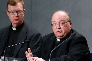 Jesuit Father Hans Zollner and Archbishop Charles J. Scicluna of Malta, members of the organizing committee for the Feb. 21-24 Vatican meeting on the protection of minors in the church, lead a press conference to preview the meeting at the Vatican Feb. 18, 2019. 