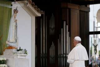 Pope Francis prays in the Little Chapel of the Apparitions at the Shrine of Our Lady of Fatima in Portugal, May 12.