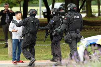 Members of a SWAT team push back members of the public following a shooting at the Al Noor Mosque in Christchurch, New Zealand, March 15, 2019. New Zealand&#039;s Catholic bishops have expressed their horror and distress at terrorist attacks on two mosques in Christchurch; at least 49 people were killed.