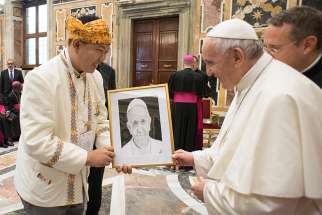 Pope Francis accepts a portrait of himself from a man attending the World Conference on Xenophobia, Racism, and Populist Nationalism in the Context of Global Migration, during an audience at the Vatican Sept. 20. The conference was held in Rome Sept. 18-20 in collaboration with the Vatican and the World Council of Churches. 