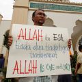 A Muslim demonstrator displays a placard to members of the media outside a mosque in Kuala Lumpur, Malaysia, Jan. 8. Some Muslims protested a recent court decision that allows a Malaysian Catholic newspaper to use the word Allah to describe God. The pla card reads: &quot;Allah is one, not two, not three, not four. Allah is one and only.&quot;