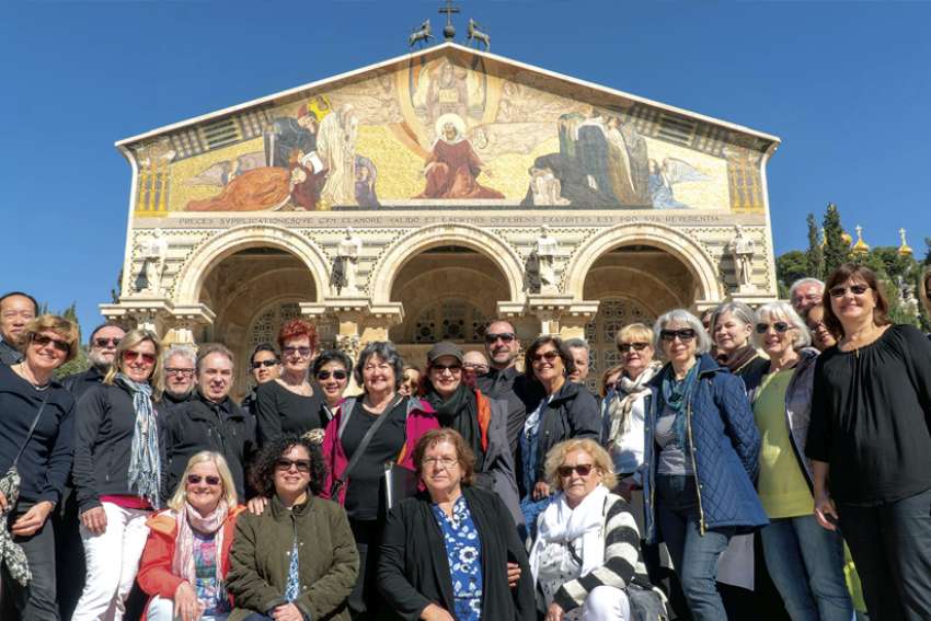 The MOSAIC Canadian Vocal Ensemble and the St. Michael’s Choir School alumni choir pose in front of the Church of All Nations in Jerusalem during their Holy Land tour. 