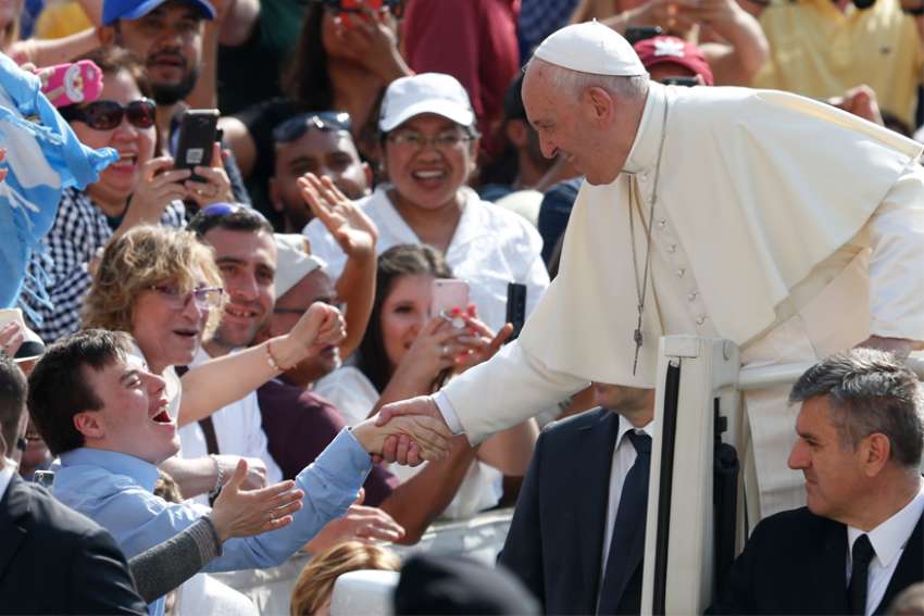 Pope Francis greets a young man during his general audience in St. Peter&#039;s Square at the Vatican June 5, 2019. 