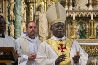 Cardinal Laurent Monsengwo Pasinya of Kinshasa, Congo, concelebrates Mass July 6 at Notre Dame Cathedral in Ottawa, Ontario. The cardinal visited Ottawa July 5-13 at the invitation of Canada&#039;s Congolese community.