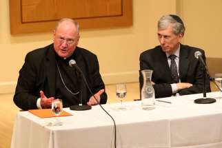 Cardinal Timothy M. Dolan of New York with Chancellor Arnold M. Eisen of the Jewish Theological Seminary of America in New York City, responds to a question during the annual John Paul II Center Lecture for Interreligious Understanding at the seminary May 6.