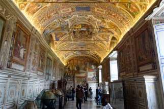 Visitors tour the Vatican Museums in this Feb. 29, 2020, file photo. The Vatican Museums will reopen June 1, almost three months after being closed as part of a lockdown to prevent spread of the coronavirus.
