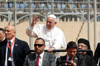 Pope Francis greets the crowd as he arrives to celebrate Mass at the Air Defense Stadium in Cairo April 29.