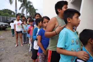 Children wait in line at a shelter in Escuintla, Guatemala, June 4. The eruption of the nearby Volcano of Fire a day earlier killed at least 69 people.
