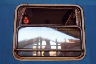 A Ukrainian girl from Kharkiv looks out a train window bound for Warsaw, Poland, with people fleeing the Russia’s ongoing war in Ukraine.