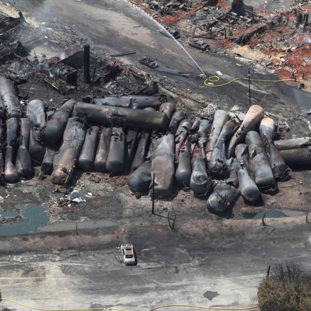 Burned train cars are seen in this July 8 aerial view following a derailment and explosion in Lac-Megantic, Quebec. Most of the town&#039;s central business district and dozens of residences were destroyed July 6 after a runaway train that was headed to a New Brunswick oil refinery derailed and exploded.