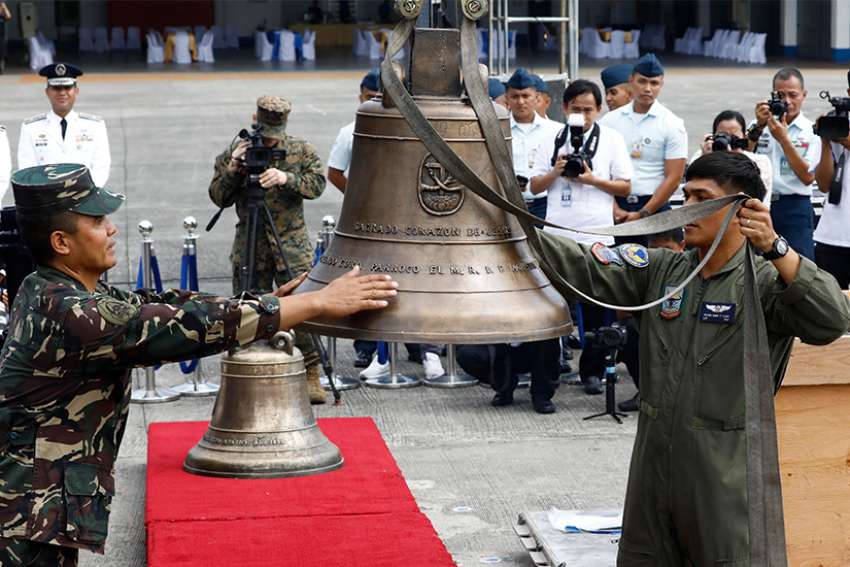  Philippine soldiers use a crane to lift three Balangiga Bells off crates during a turnover ceremony Dec. 11 at Villamor Air Base near Manila. After more than a century, the United States government has returned the three church bells swiped by American forces as war booty from the central Philippine town of Balangiga in 1901. 