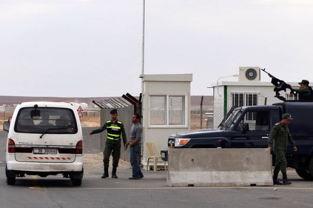 Police officers stand guard at the entrance to the new Azraq Syrian refugee camp, which is under construction east of Amman, Jordan, March 25. Azraq Refugee Camp will open April 30, according to a U.N. official.