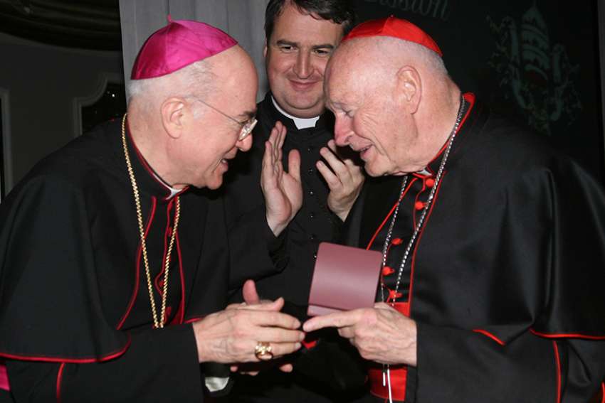 Archbishop Carlo Maria Vigano, then nuncio to the United States, congratulates then-Cardinal Theodore E. McCarrick of Washington at a gala dinner sponsored by the Pontifical Missions Societies in New York in May 2012. The archbishop has since said Cardinal McCarrick already was under sanctions at that time, including being banned from traveling and giving lectures.