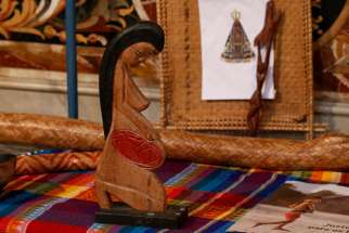 A wooden statue of a pregnant woman is pictured in the Church of St. Mary in Traspontina as part of exhibits on the Amazon region during the Synod of Bishops for the Amazon in Rome Oct., 2019.