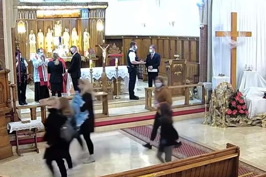 Police in London stand on the altar at Christ the King Polish church and halted a Good Friday service after a complaint that pandemic regulations were not being met. The parish claims police &quot;brutally exceeded their powers.&quot;
