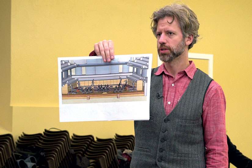 Joel Ivany, stage director, holds up a sketch of his semi-staged production of Mozart’s Requiem during rehearsals. Ivany promises the performance will be a dramatic and engaging experience.