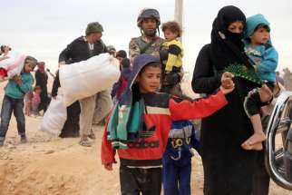 Syrian refugees arrive at a refugee camp in early May at the Jordan border with Syria. The Catholic Church in England and Wales has joined a government project to resettle an estimated 20,000 refugees from the Syrian war.