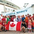 Some of the 134 Canadians who volunteered aboard the Africa Mercy in 2012 pose for a photo while docked in a port in Guyana.