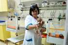A nurse holds a baby at the St. Rachel’s Centre, Caritas Baby Hospital, one of the  projects the Equestrian Order of the Holy Sepulchre supports in the Holy Land.