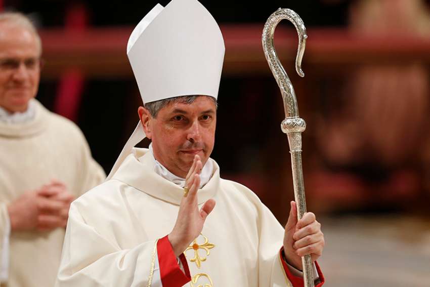  New Archbishop Jose Bettencourt, a priest of the Archdiocese of Ottawa and former head of diplomatic protocol for the Vatican, greets the faithful during his episcopal ordination by Pope Francis in St. Peter&#039;s Basilica at the Vatican March 19. Archbishop Bettencourt was among three new nuncios ordained as archbishops by the pope.